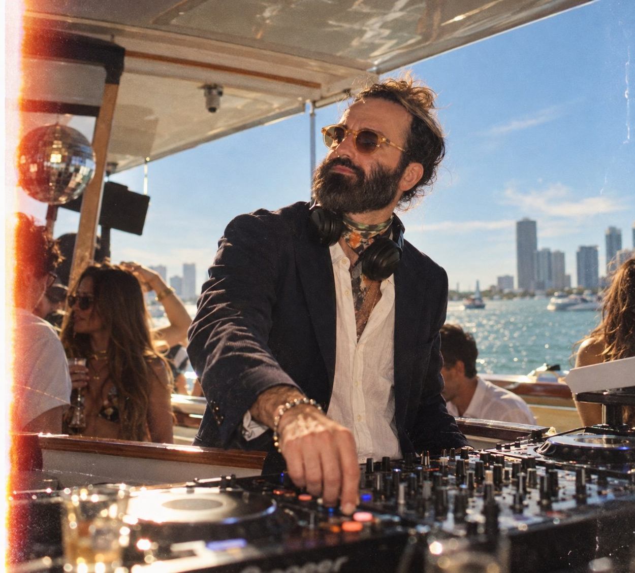 DJ Bones mixing on a boat in a blazer