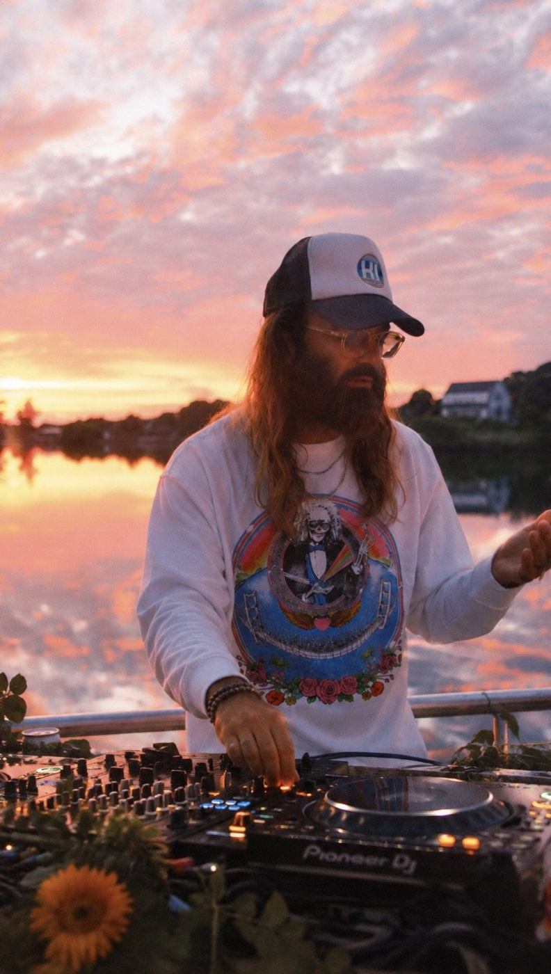 DJ Bones mixing at sunset by the water